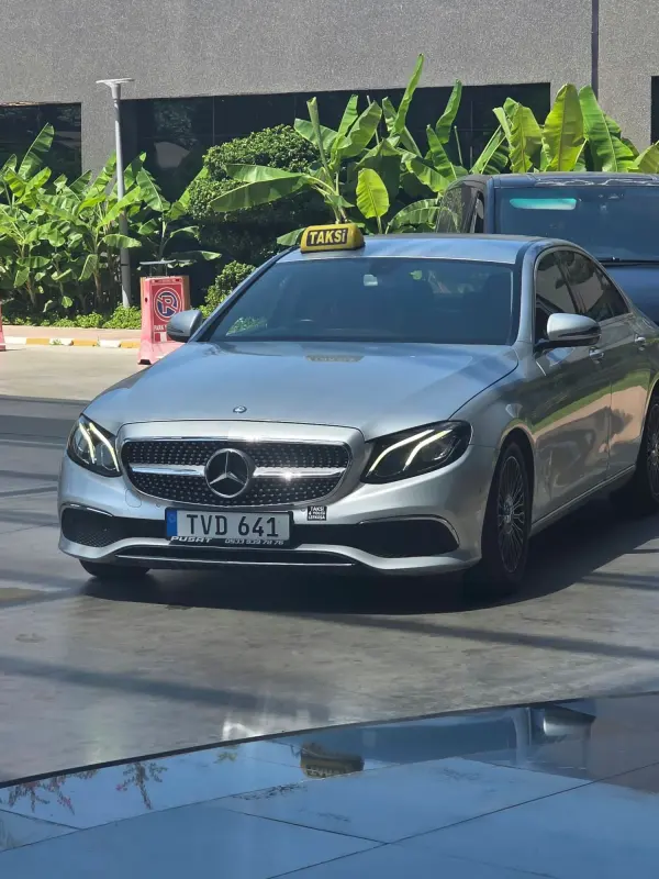 Mercedes E-Class VIP taxi outside a hotel
